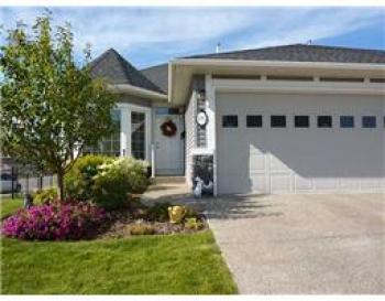 Beautiful Bungalow Villa backing onto the canal in Rainbow Falls area of Chestermere. 